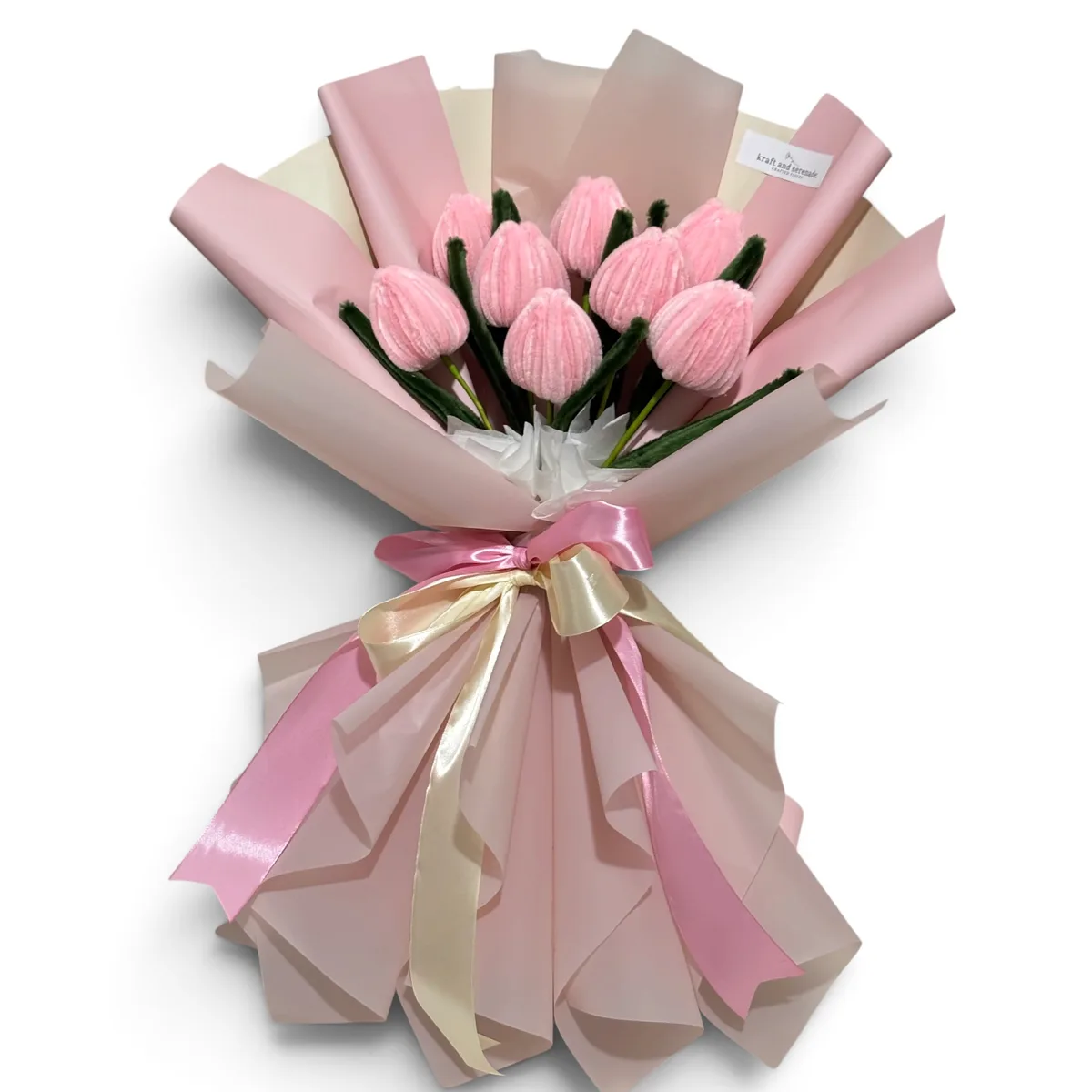 A single pink tulip against a pale pink backdrop