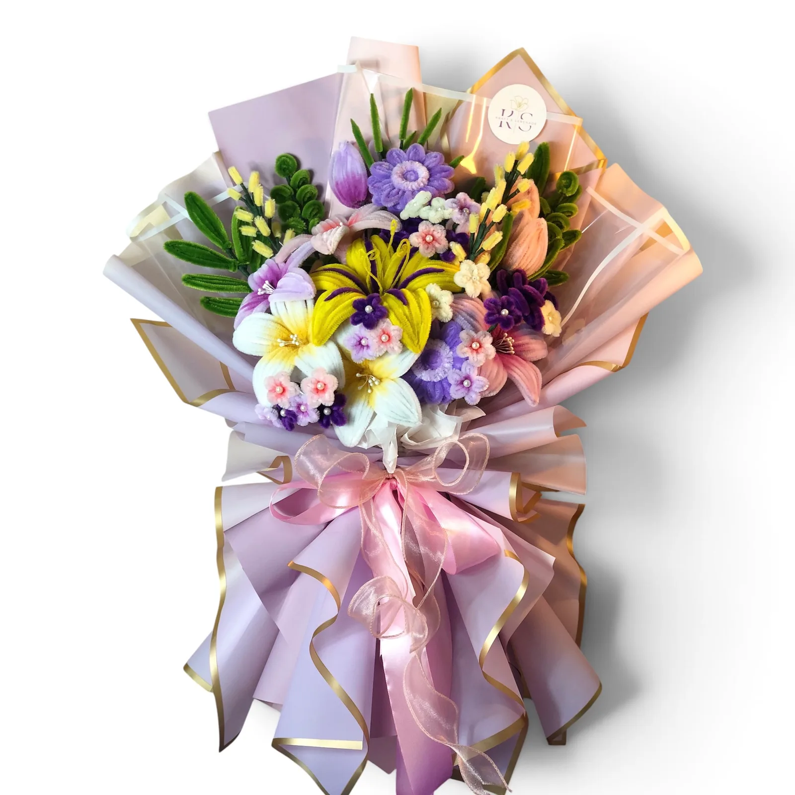 The arrangement features lillies, gerberas, tulips, rose blooms, and rapunzel sundrop flowers, complemented by baby's breaths, ash leaf, eucalyptus, mini daisies and grass-like leaf as fillers.