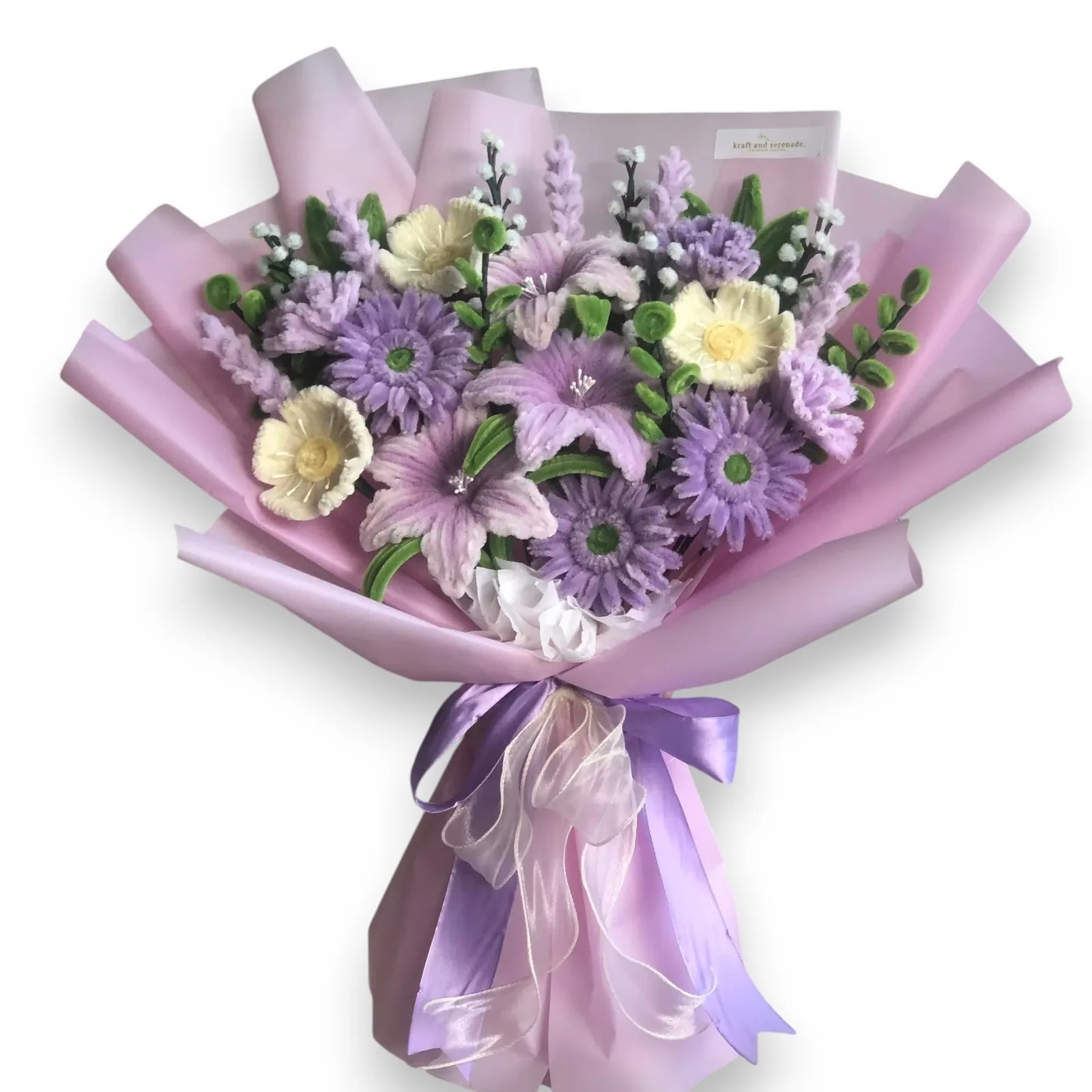 The arrangement features lillies, gerberas, carnations, and poppy flowers, complemented by baby's breaths, ash leaf, eucalyptus, and lavender as fillers.