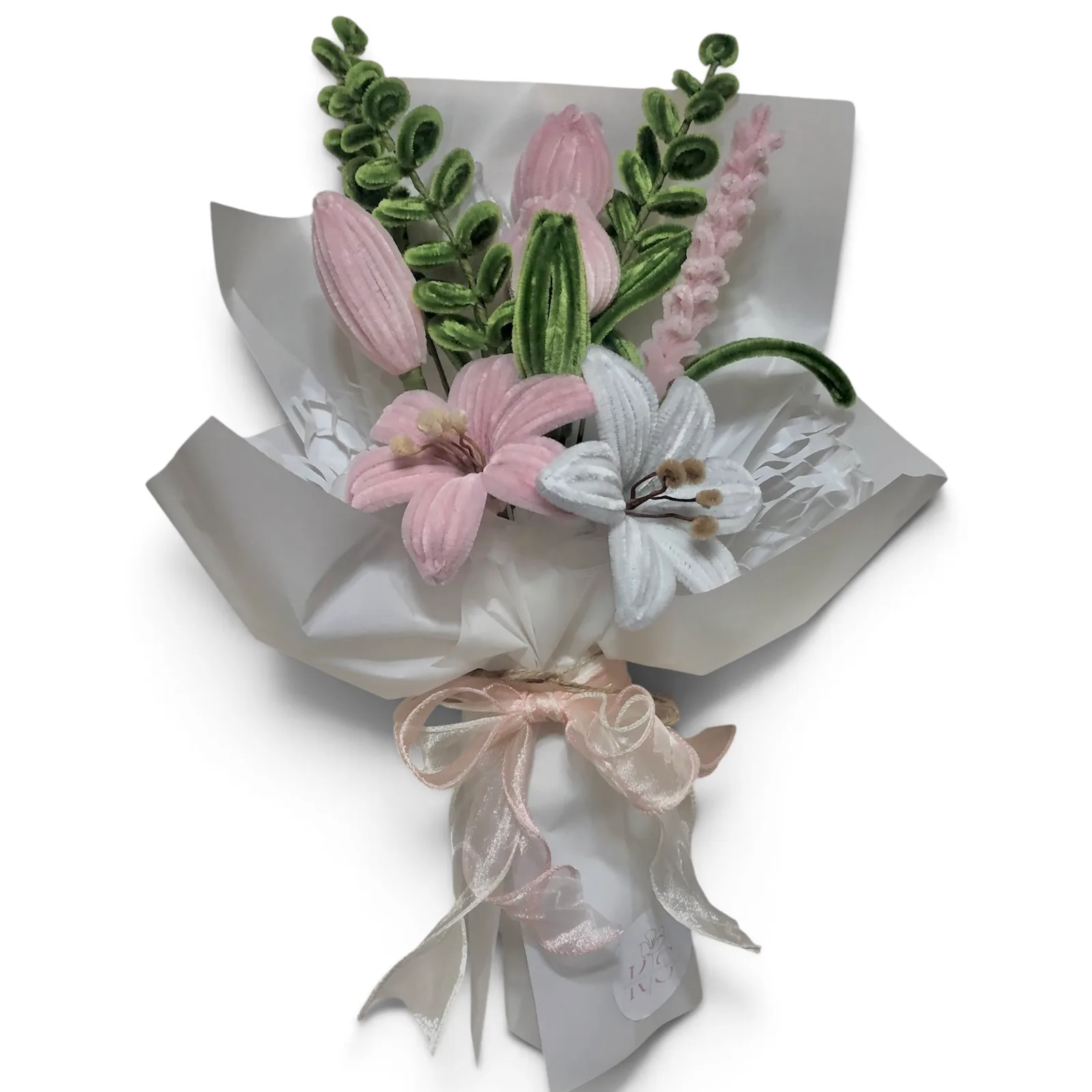The arrangement features tulips, and lily flowers, complemented by flower buds, eucalyptus, and lavender as fillers.