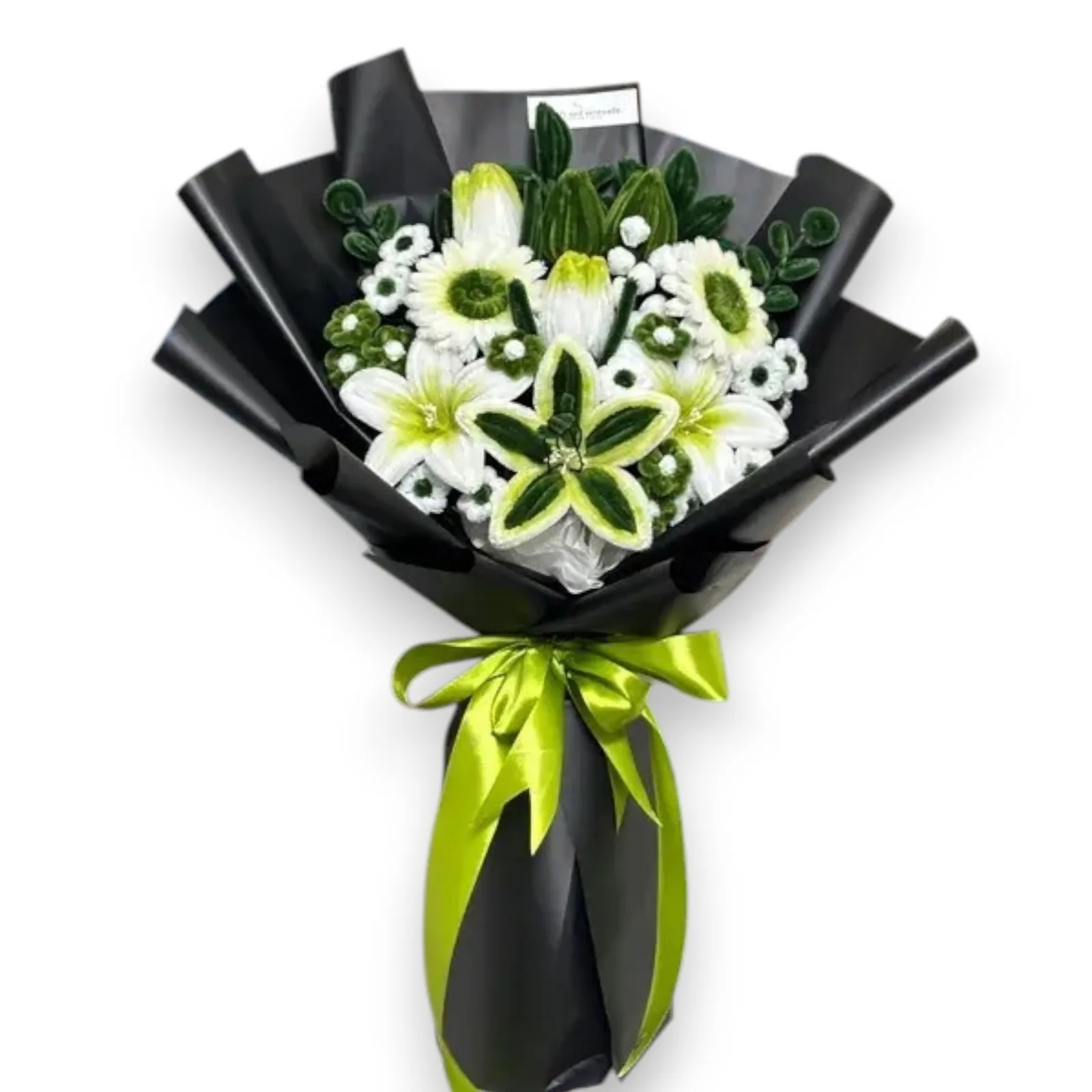 The arrangement features lillies, gerberas and tulip flowers, complemented by mini daisies, eucalyptus and ash leaf as fillers.
