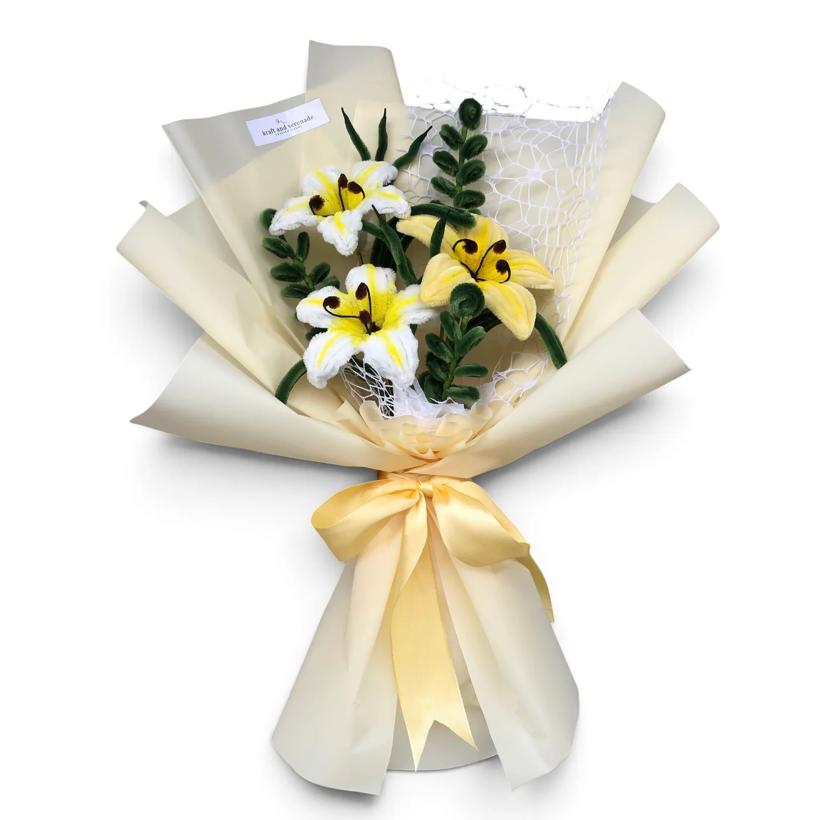 It features lily flowers paired with eucalyptus and grass-like fillers.