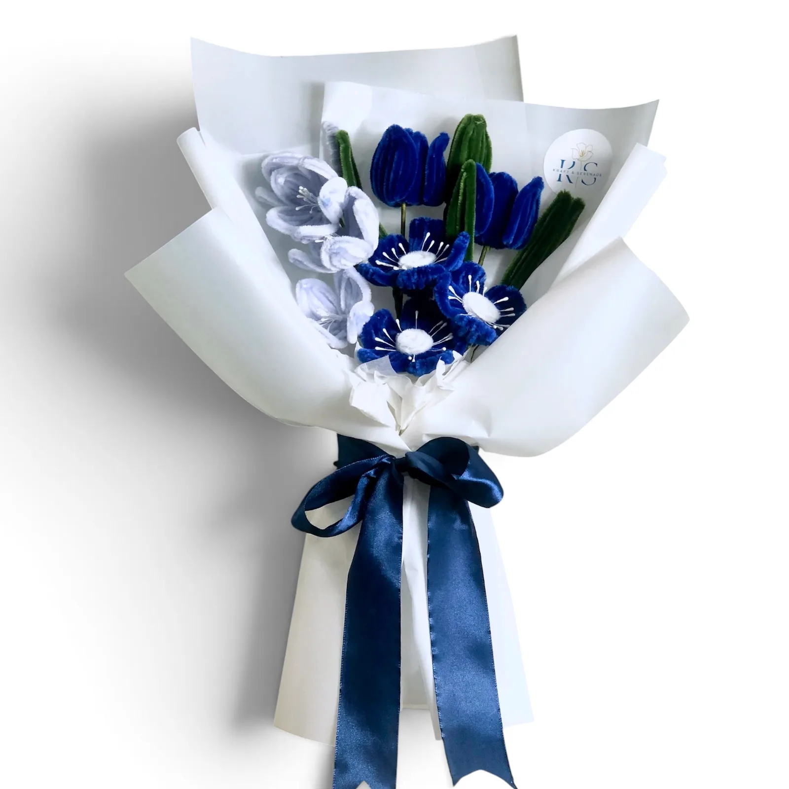 The arrangement features tulips, small lilly and poppy flowers, complemented by flower bud as fillers.