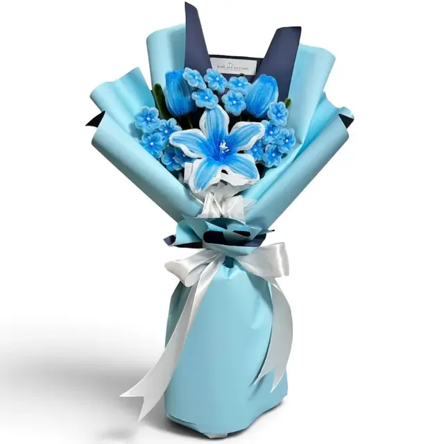 The arrangement features tulips and lily flowers, complemented by mini daisies as fillers.