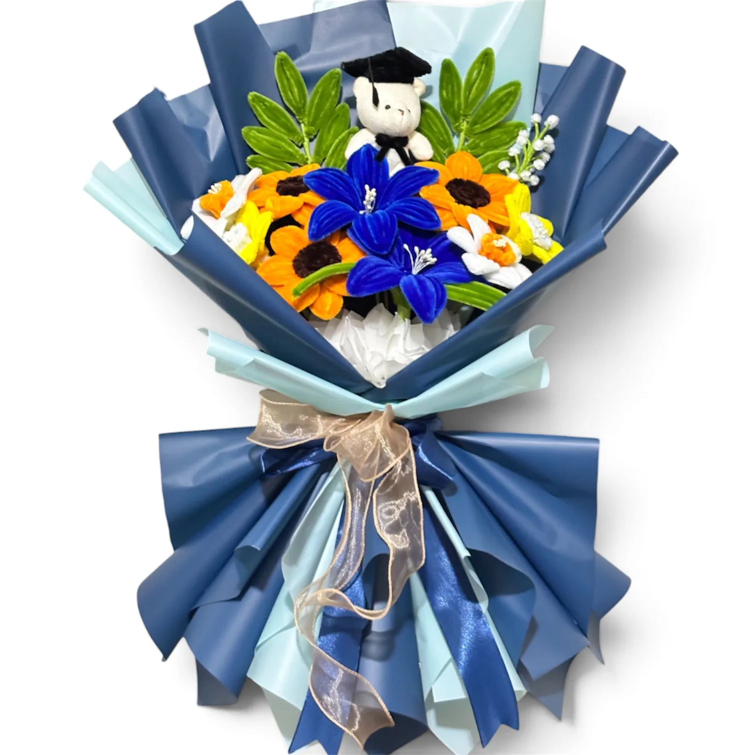 The arrangement lilies, sunflowers, and daffodil flowers, complemented by ash leaves and baby's breath as fillers, and graduation mini bear as additional.