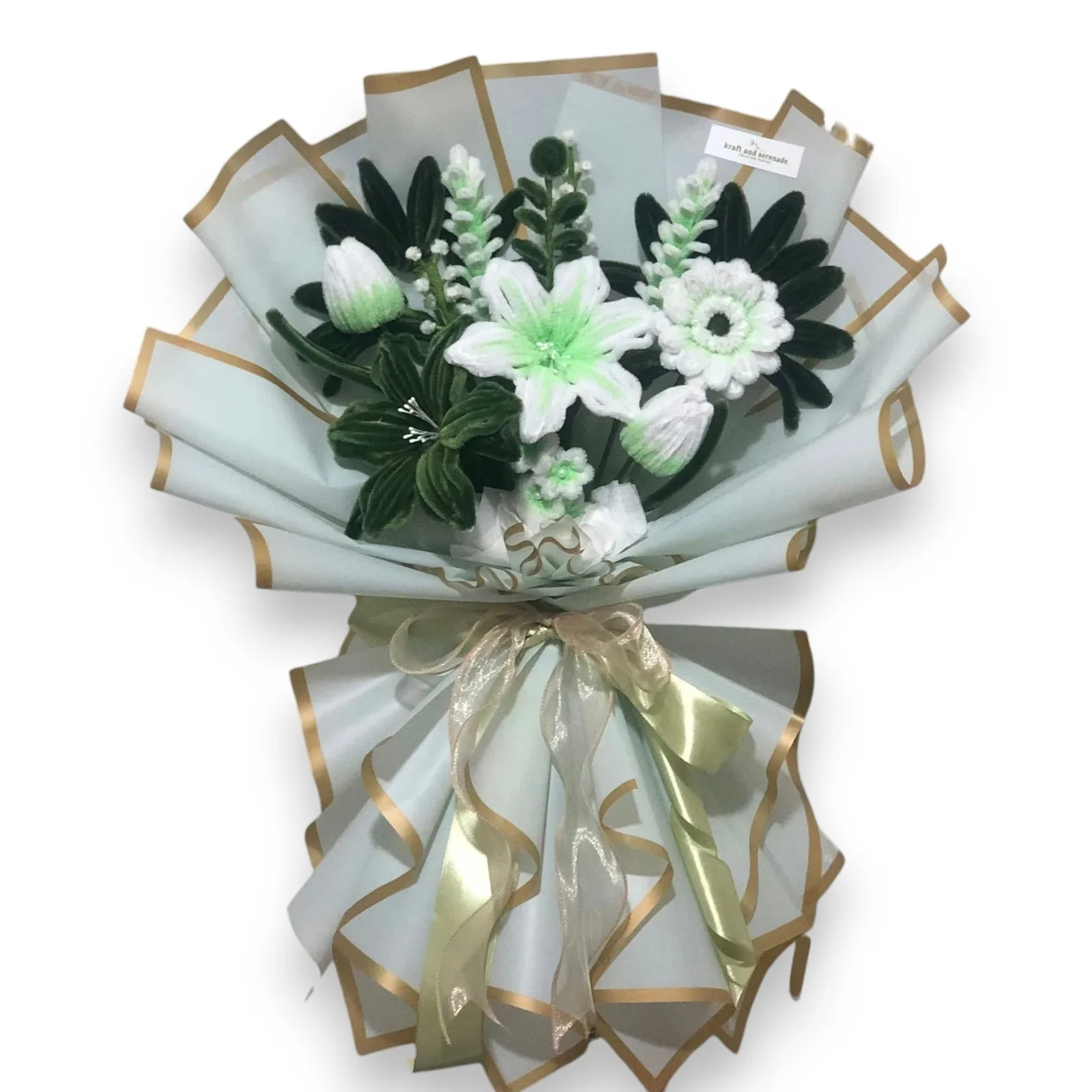 The arrangement features lilies, gerbera and tulip flowers, complemented by mini daisies, baby's breath, eucalyptus, lavenders, and american ash leaves as fillers.