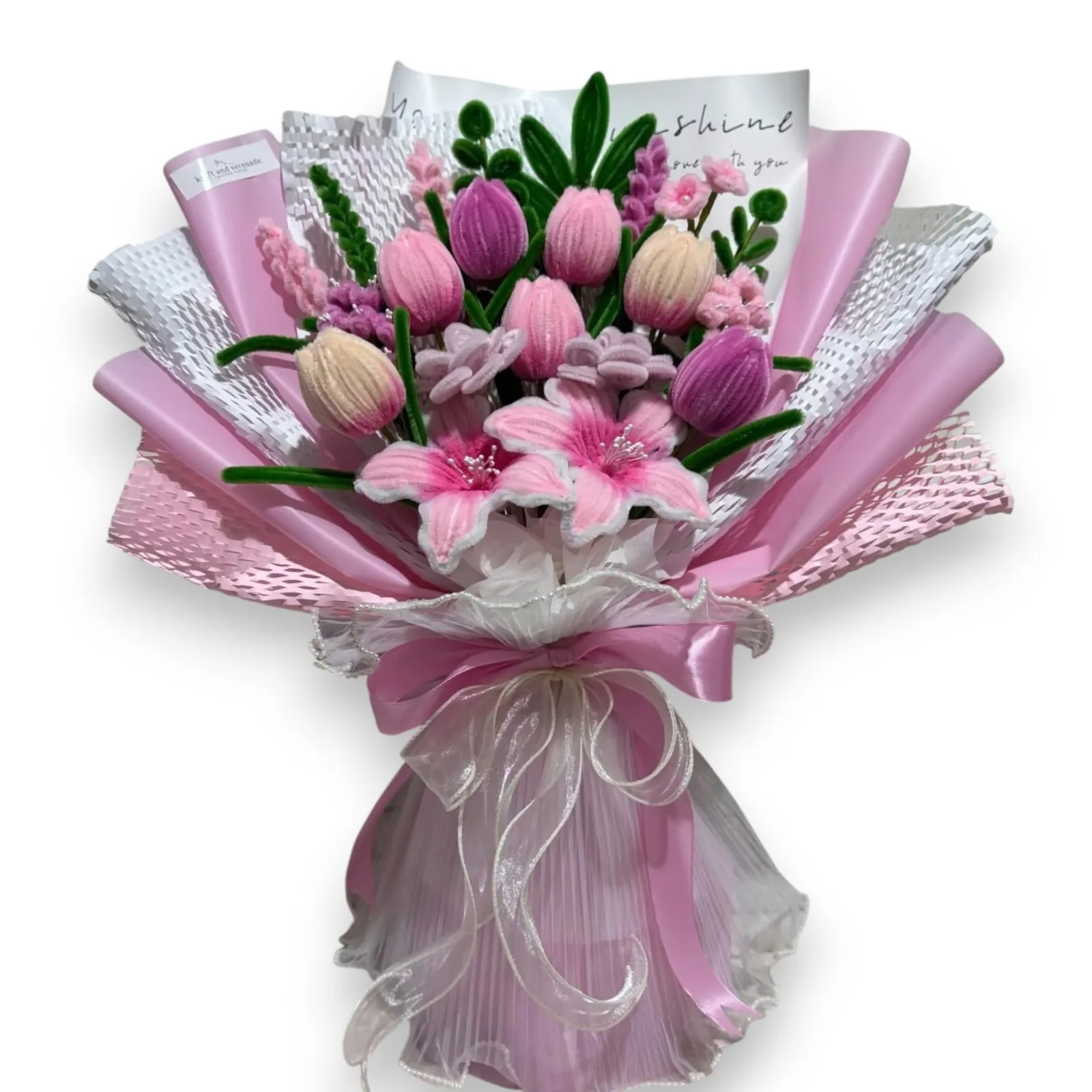 The arrangement features lilies, tulips and rose bloom flowers, complemented by eucalyptus, ash leaf, mini daisies and lavenders as fillers.