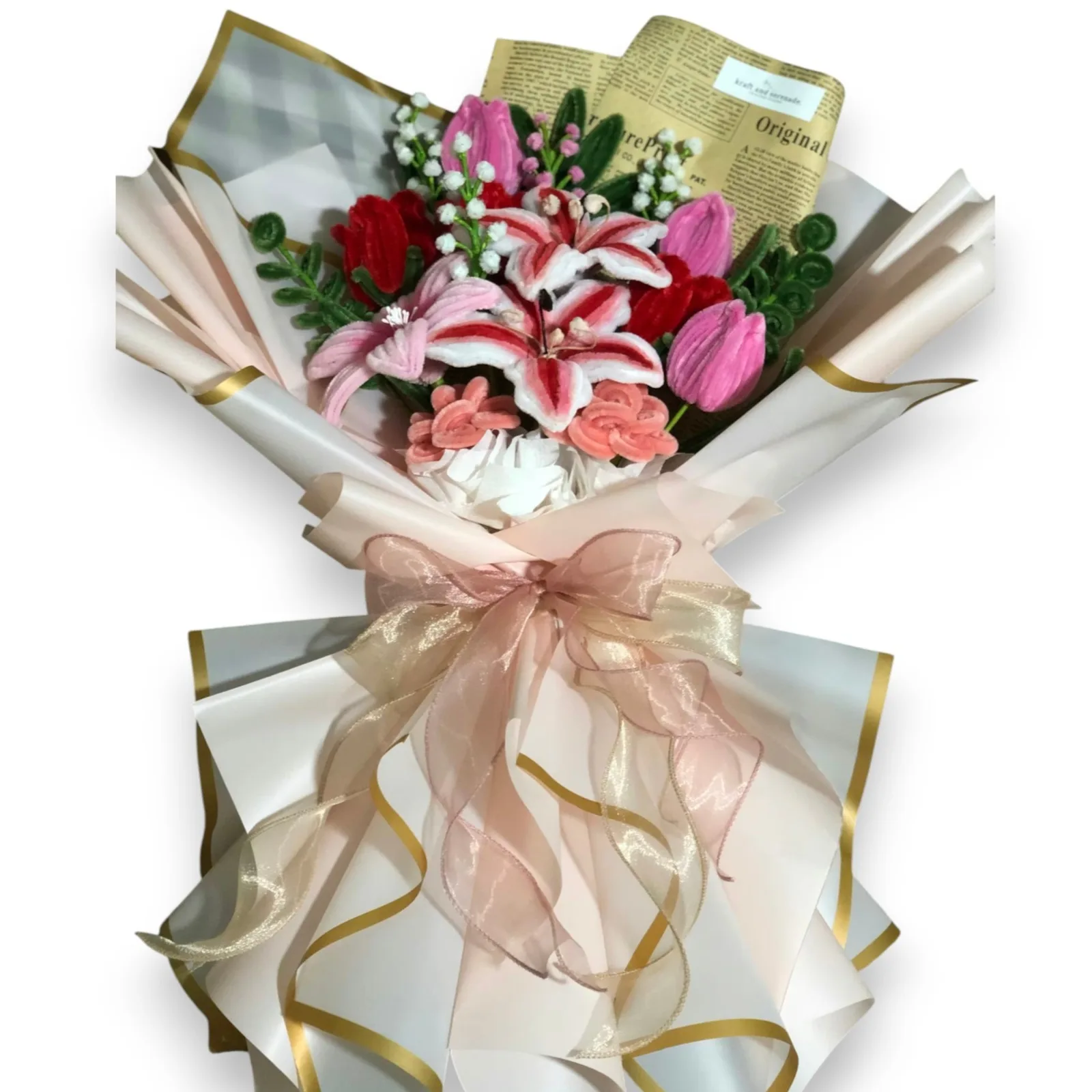 The arrangement features tulips, lilies and rose flowers, complemented by baby's breaths, eucalyptus, and ash leaf as fillers.