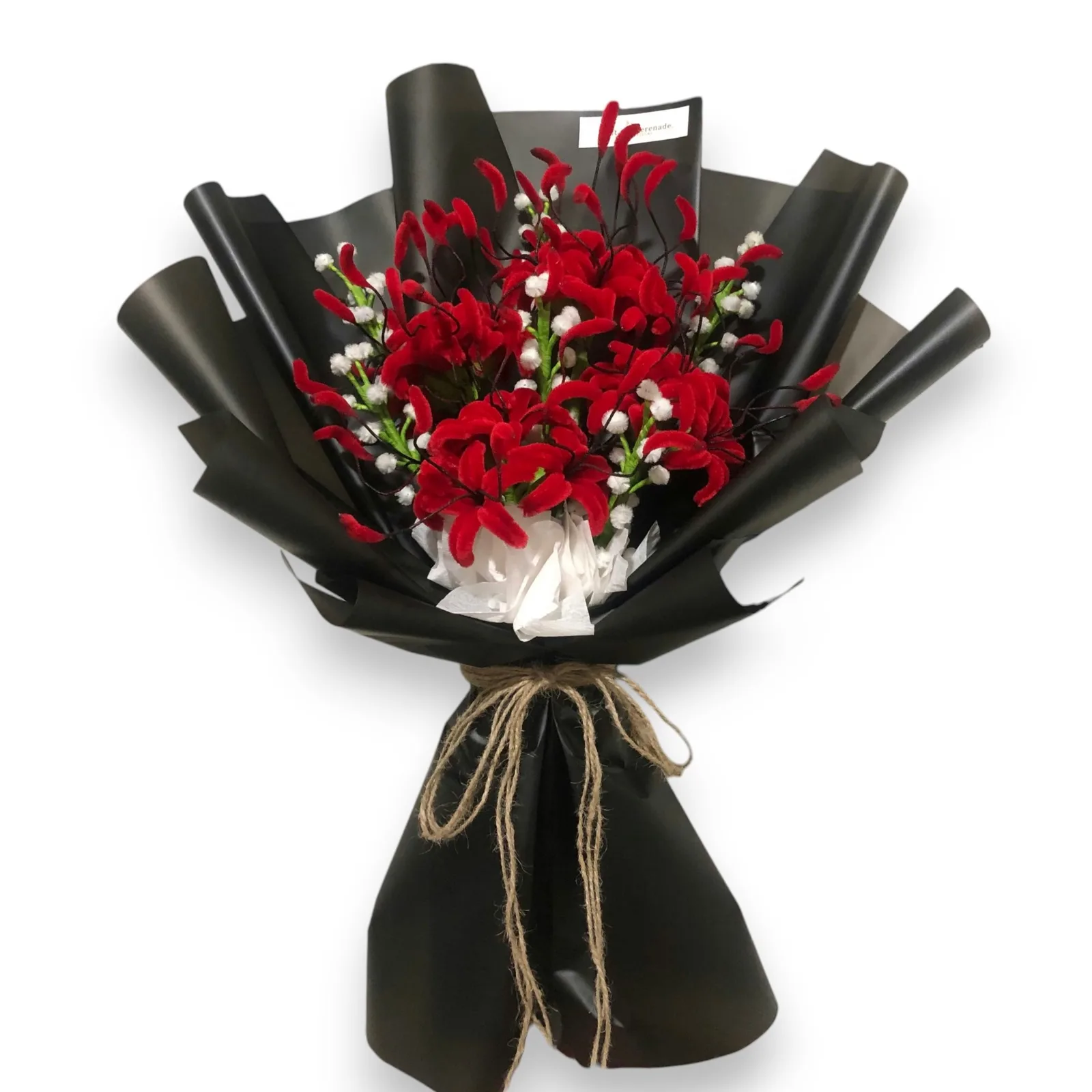 The arrangement features spider lily flowers, complemented by baby's breath as fillers.