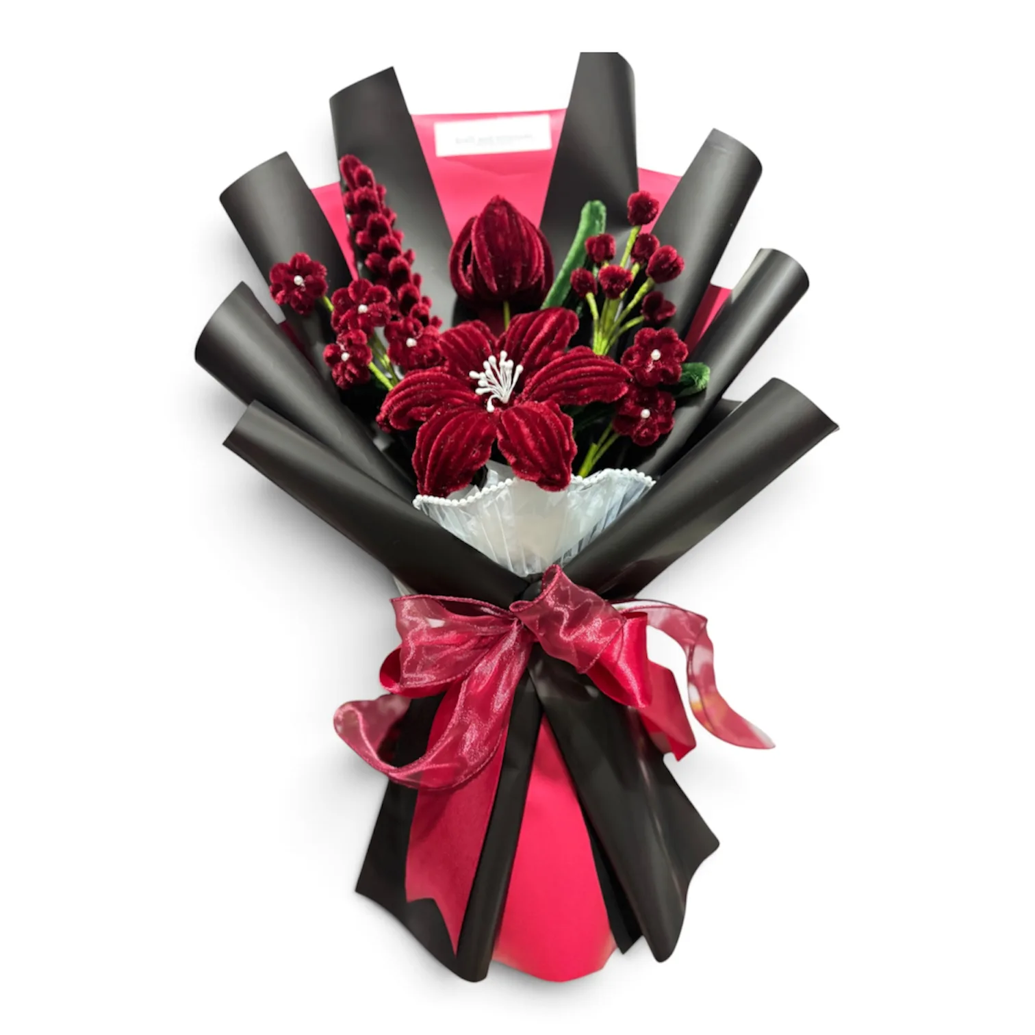 The arrangement features lily and tulip flowers, complemented by lavender, mini daisies, and chucky baby's breath as fillers.