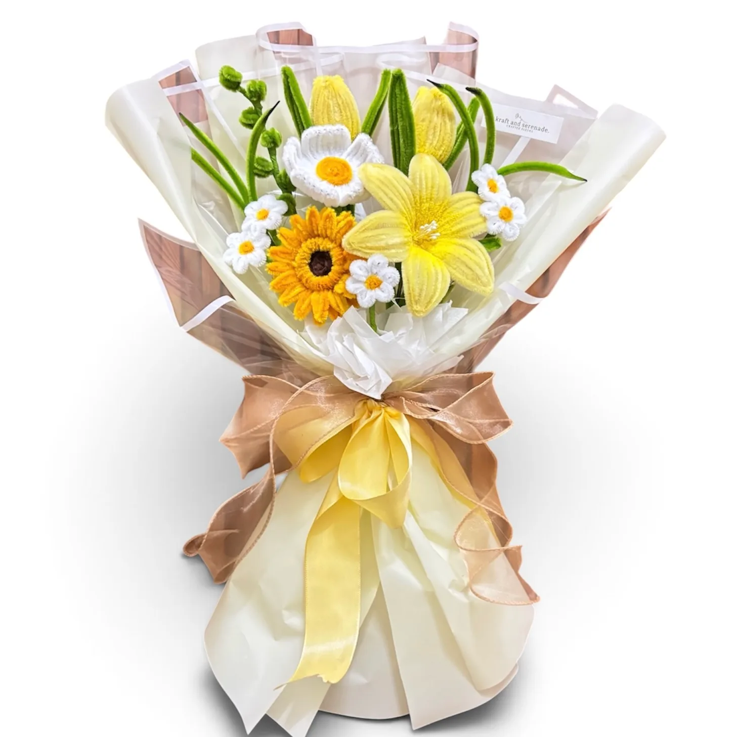 Handcrafted fuzzy wire bouquet featuring a gerbera daisy, lily blooms, poppy flower, daisy accents, and lush greenery in yellow tones.