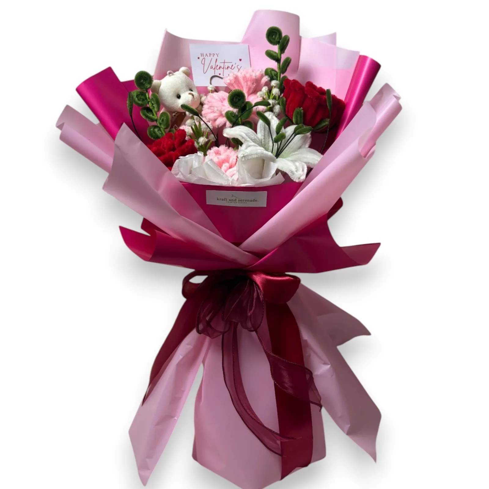 The arrangement features large roses, carnations, lily, and gerbera flowers, complemented by baby's breaths and eucalyptus as fillers and mini bear as additional.
