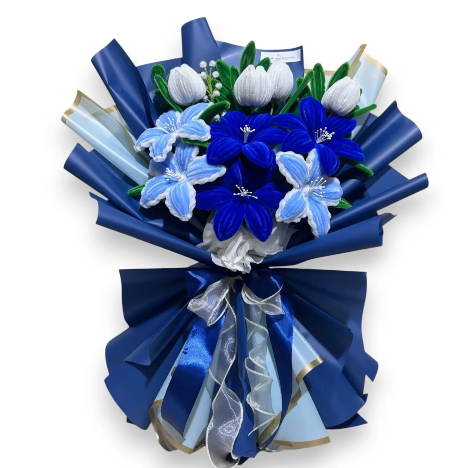 The arrangement features tulips, and lily flowers, complemented by baby's breath, eucalyptus, and ash leaf as fillers.