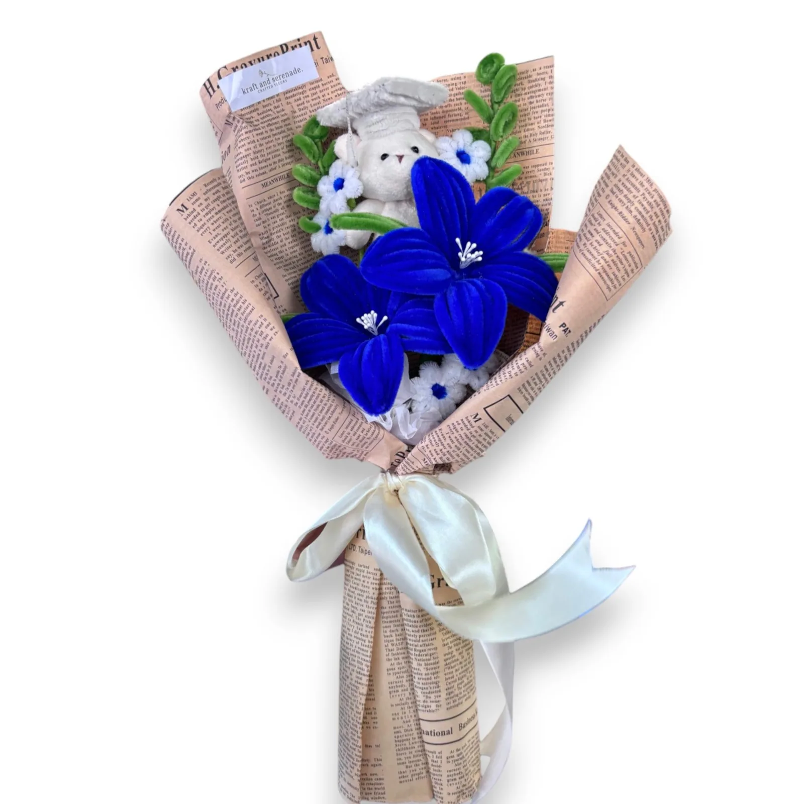 The arrangement lily flowers, complemented by mini daisies and eucalyptus as fillers, and graduation mini bear as additional.